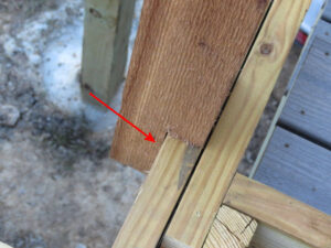 a notched wooden railing post