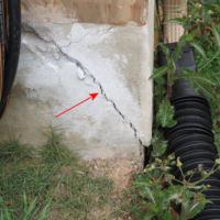 Spalling at the foundation corners usually caused by lack of the required bond breaker at the brick ledge and/or improper placement of the expansion joints in the brick veneer. cosmetic foundation crack
